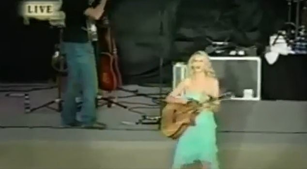 The clip, which was posted to Reddit, shows Swift in her days as a country singer with curly hair, a bright green ruffled dress, and an acoustic guitar.