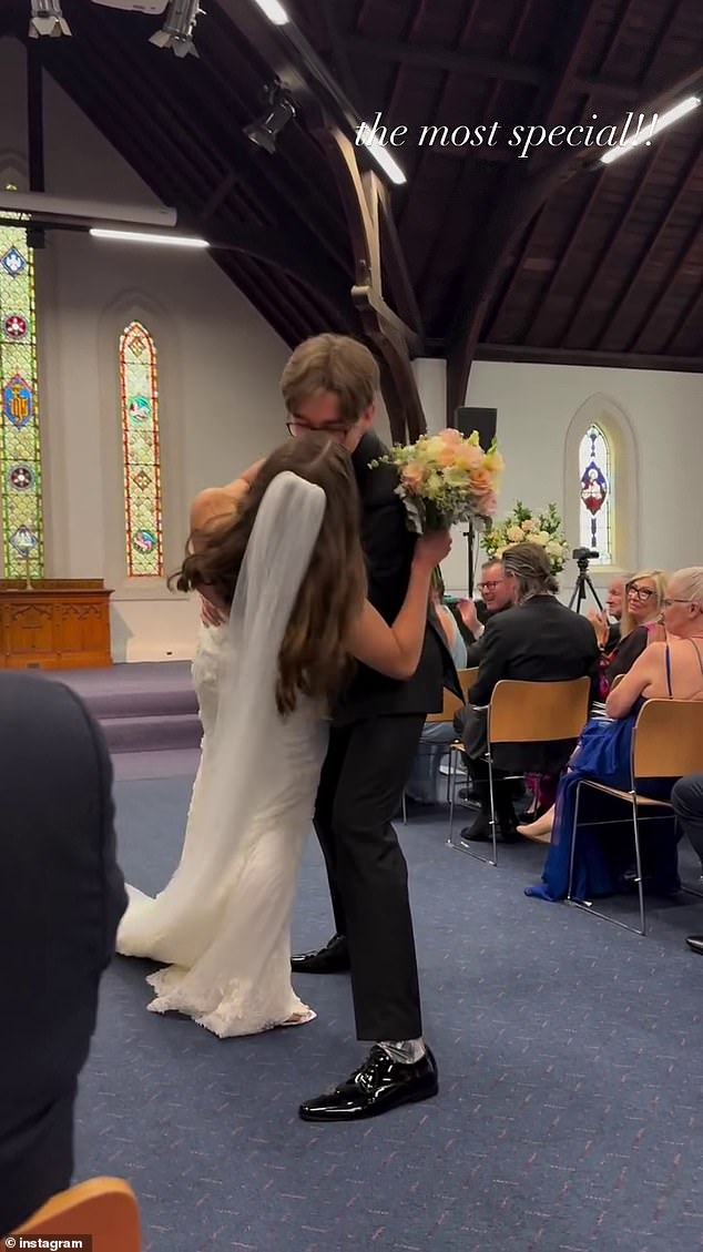 In a sweet moment, Cooper immersed his new wife at the end of the altar after they said 'I do' to share a romantic kiss.