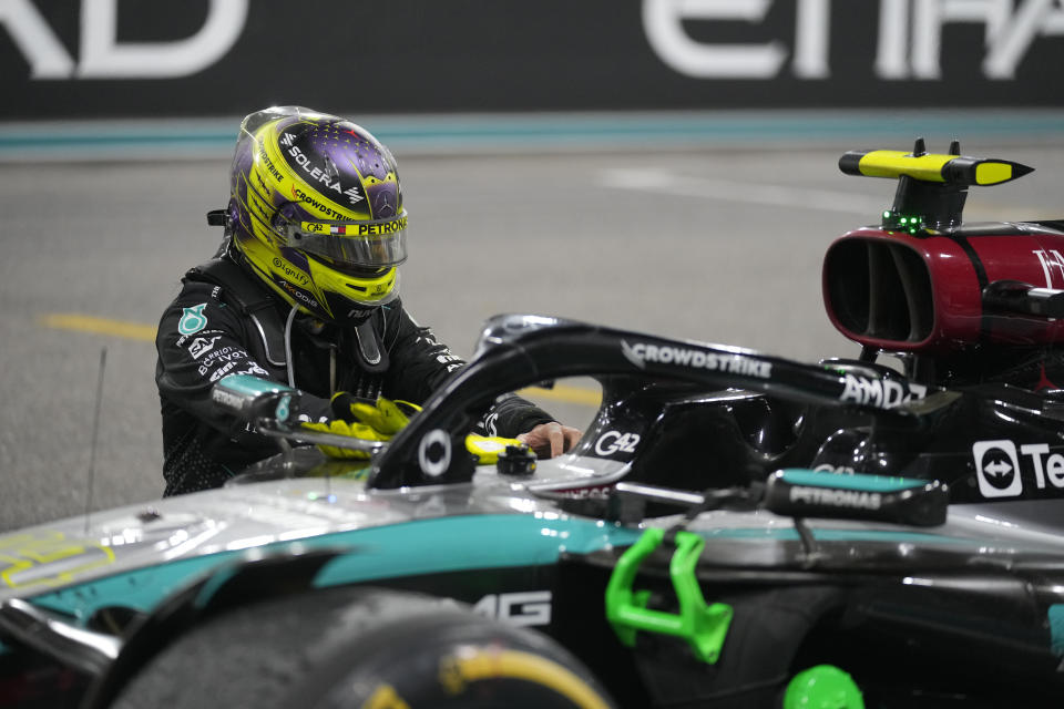 Britain's Lewis Hamilton kneels next to his car after his final race with the Mercedes team following the Formula One Abu Dhabi Grand Prix at the Yas Marina Circuit in Abu Dhabi, United Arab Emirates, Sunday, December 8, 2024 (AP Photo/Darko Bandic)