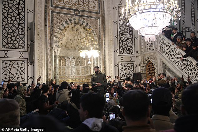 Abu Mohammed al-Jolani addresses a crowd at the capital's iconic Umayyad Mosque.