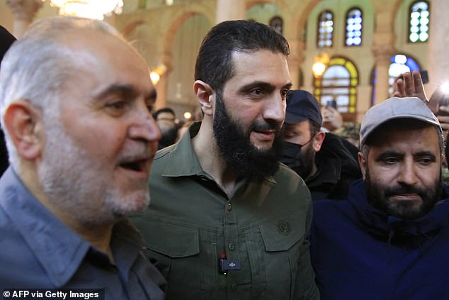 Abu Mohammed al-Jolani (center), before his speech at the capital's emblematic Umayyad Mosque.