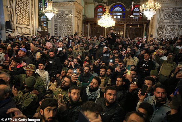 Abu Mohammed al-Jolani (not pictured) is filmed by his supporters at the capital's iconic Umayyad Mosque.