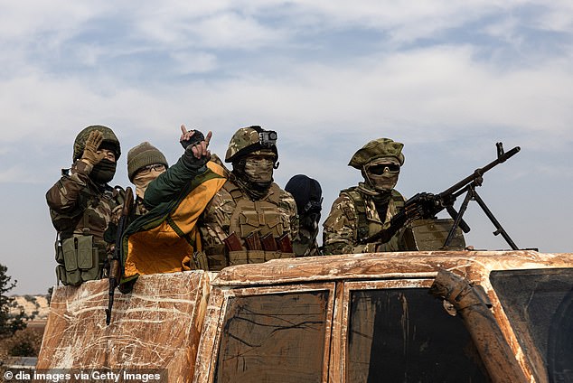 Syrian National Army soldiers celebrate in the city after opposition forces led by HTS (Hayyet Tahrir al-Sham) took control of Hama city center and surrounding villages on December 6.