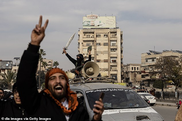 Local residents celebrate after opposition forces led by HTS (Hayyet Tahrir al-Sham) took control of Hama city center and surrounding villages on December 6.