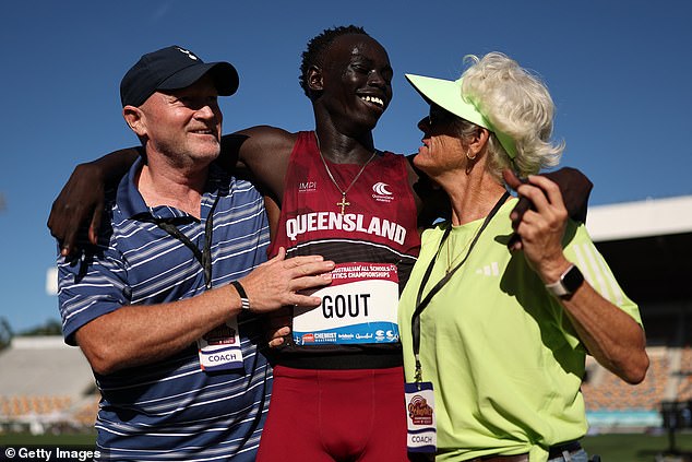 After the race, the sprinter was seen celebrating with his manager James Templeton (left) and coach Di Sheppard (right).