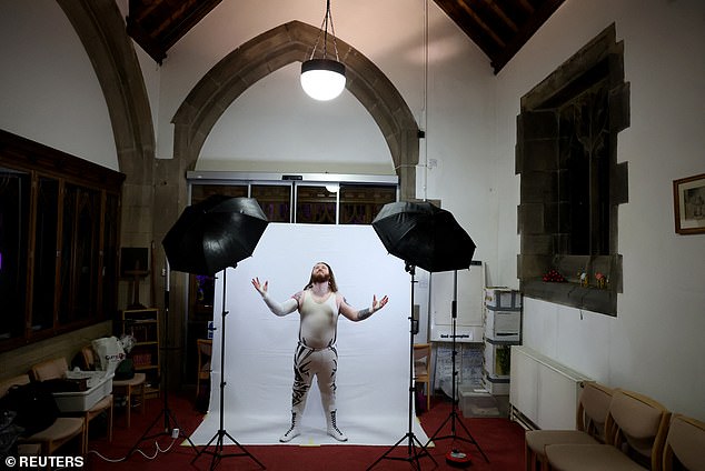 Wrestler William Valor poses for a photographer before his fight in the church.