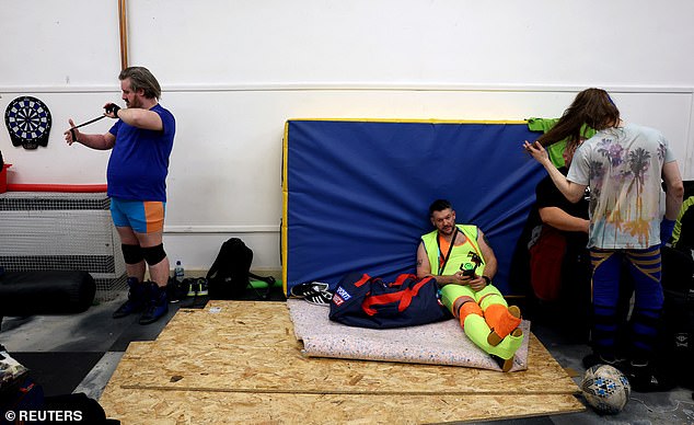 Wrestlers prepare in a dressing room backstage before the Kingdom Wrestling Toyal Rumble