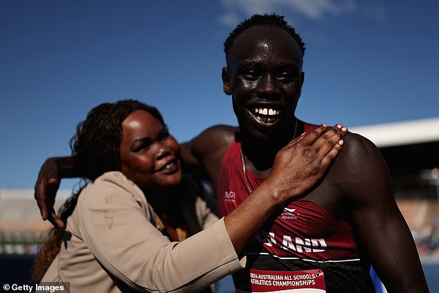 Gout Gout celebrates his recent success with his mother after breaking the 200 meter record.