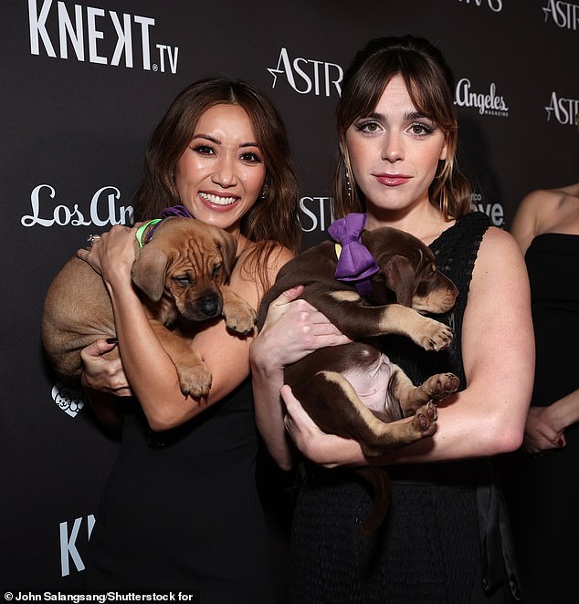 The Blue Eye Samurai star got to hug adorable Petco-sponsored pups on the red carpet alongside her The Last Showgirl co-star Kiernan Shipka (right).