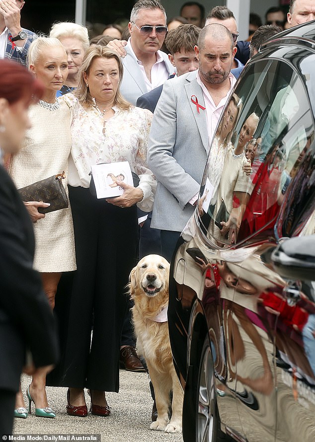 Bianca Jones' mother is seen on the left supported by Holly Bowles' mother. The family's golden retriever, Zara, was also at the service.