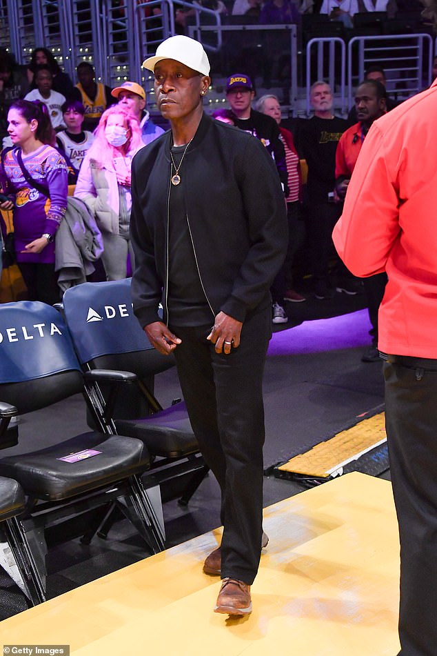 While Don, 60, looked effortlessly cool in a black bomber jacket and jeans, with a cream baseball cap and a gold pendant necklace