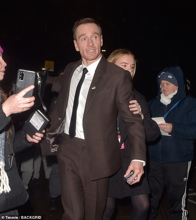 Michael was surrounded by autograph and selfie hunters as he made his way to his car