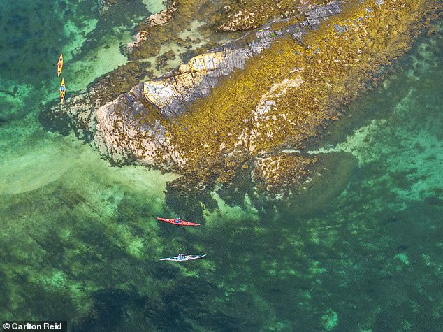 Carlton's drone shot of Eilean na Creige Duibhe (Black Rock Island), which is located near Plockton, and its emerald green waters. Two kayakers, in yellow boats, join Jude and Lee.