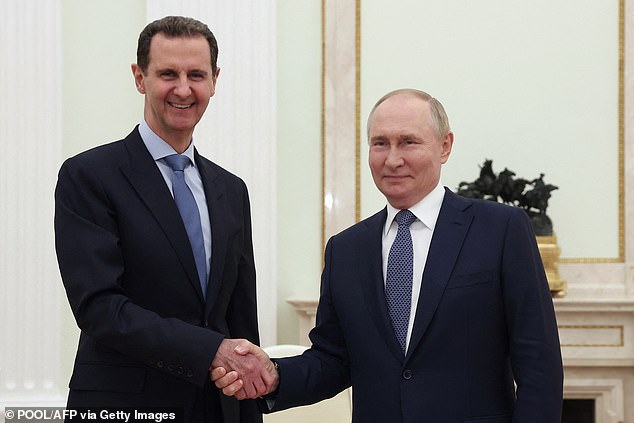 Russian President Vladimir Putin (right) shakes hands with his Syrian counterpart Bashar al-Assad during their meeting at the Moscow Kremlin on July 24, 2024.