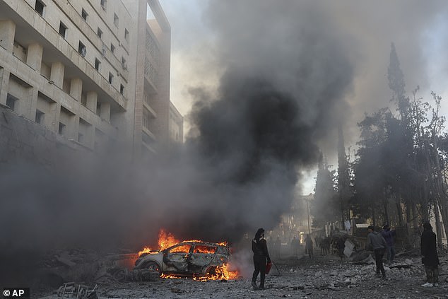 A car burns after an airstrike next to a hospital in Idlib, Syria, Monday, December 2, 2024