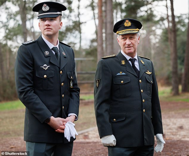 Like father like son! The King and Prince lined up together to watch the troops training.