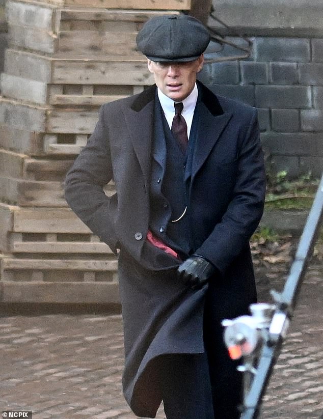 Also sporting black leather gloves, the images show that the feature film will be set in a cold season.