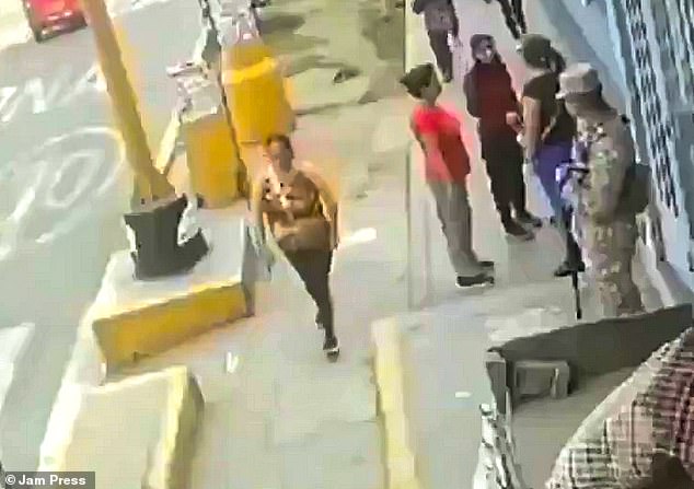 Elvira Taipe, mother of two children, steps on the concrete cover of an electrical box before it explodes