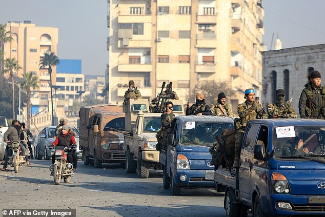 Rebels parade in the streets of Hama after forces captured the central city on December 6.