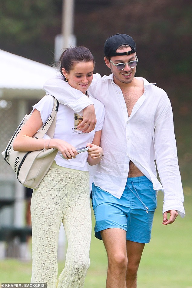 Arriving at the beach date, Willow cut a summer figure in a simple white graphic T-shirt that she paired with semi-sheer pants.