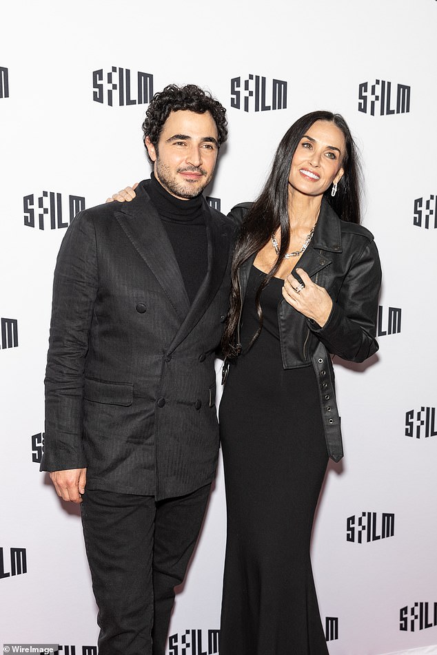 Fashion designer Zac Posen, whom Demi supported early in her career, wore a striped double-breasted sports jacket with a high collar and jeans.