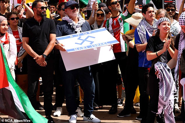 Alan Yazbek (wearing a black cap and holding a sign) appears at a protest in Sydney. Daily Mail Australia suggests no wrongdoing by others in the photograph