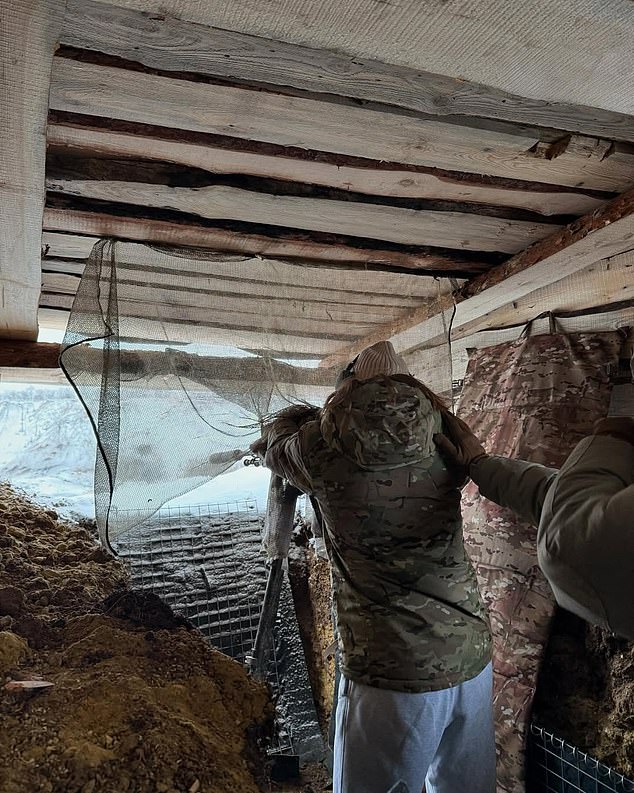 Another photo showed the Ukrainian using a machine gun from a sheltered area