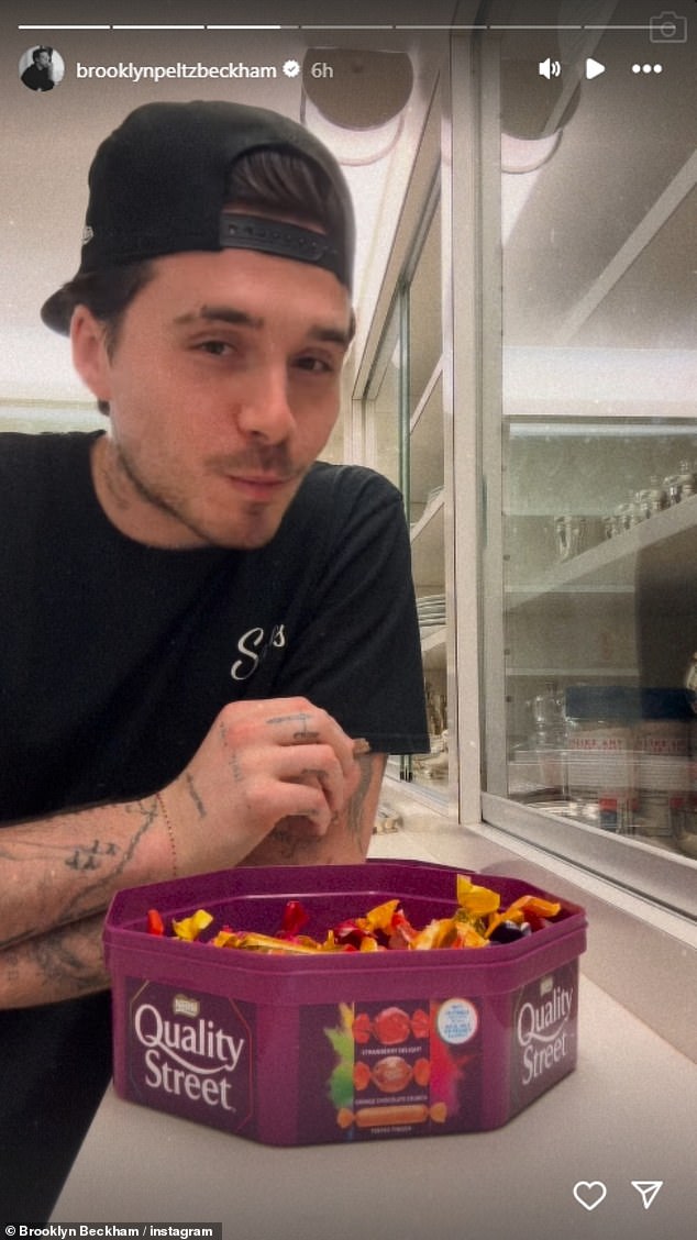 Wearing a black t-shirt and a cap, he began to bite into the house's favorite candy.