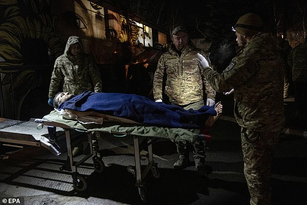 Hospitallers medical staff carry an injured Ukrainian soldier onto their medical bus for transport to a hospital, in the Donetsk region, Ukraine, on December 6, 2024.