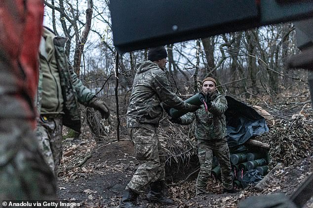 Ukrainian soldiers unload ammunition from an armored vehicle at its combat position in the direction of Toretsk