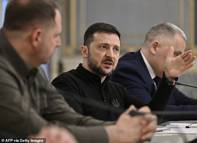 Ukrainian President Volodymyr Zelensky speaks with the leader of Germany's Christian Democratic Union (CDU) during their meeting in kyiv on December 9, 2024.