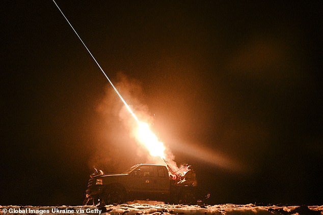 Ukrainian servicemen of the mobile air defense unit fire a machine gun at Russian drones during a night patrol on December 2