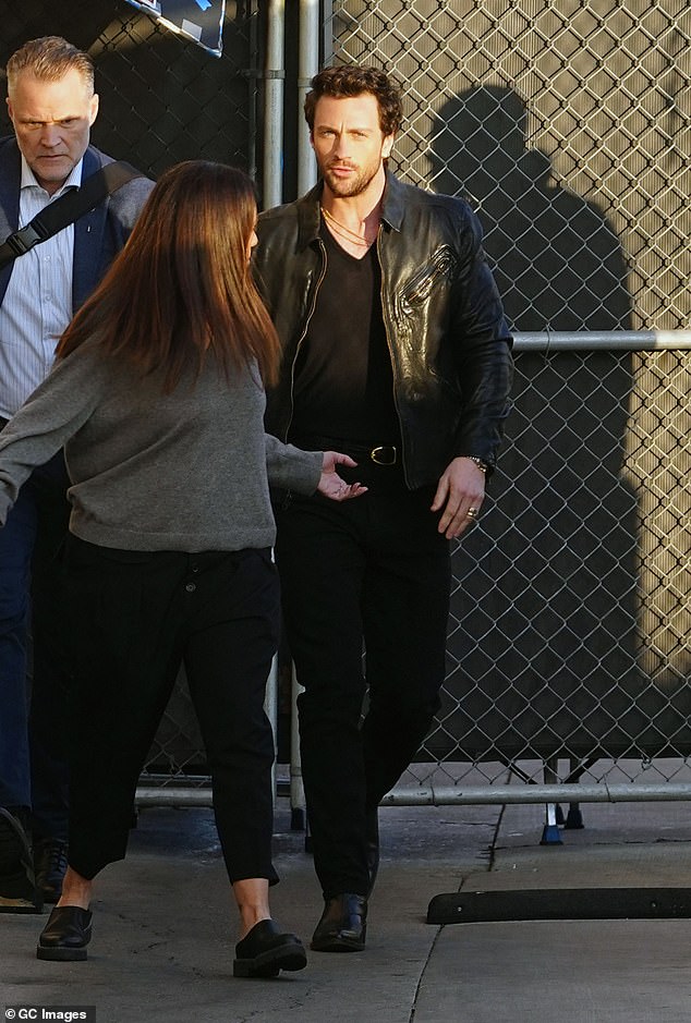 To accessorize, Aaron kept it simple with black leather Chelsea boots and a slew of gold chains around his neck.