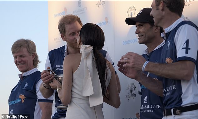 The Duke of Sussex beamed from ear to ear as the pair prepared for a kiss in front of waiting photographers and the Netflix camera crew.