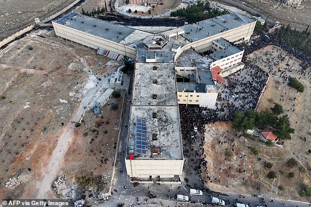 An aerial photograph shows people gathered at the Sednaya prison in Damascus on December 9.