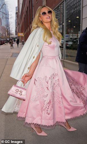 The influencer, 43, seemed to emulate Glinda, the 'good' witch from Wicked. For her 'magical' look, the reality star chose a pastel pink dress with short sleeves, a flared waist and a large flower print.