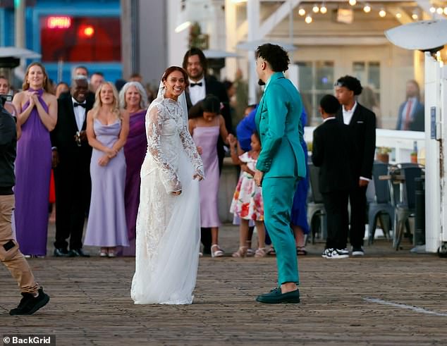 The couple was seen dancing together on the pier as their family and friends looked on during the romantic ceremony.