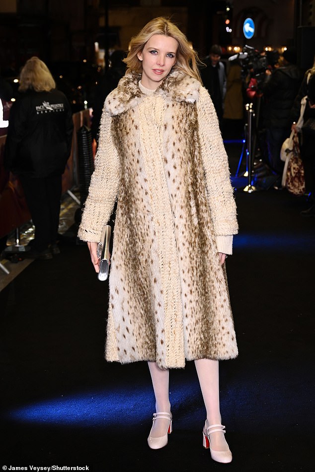 Greta Bellamacina looked sensational in a white knit dress that she paired with a long white fur vest with a leopard print.