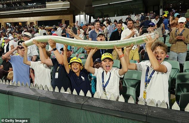 Burtt, 21, helped build the snake with seven mates at the Adelaide Oval and before long up to 250 cups were used during the day-night test (pictured, young fans delighting the crowd).