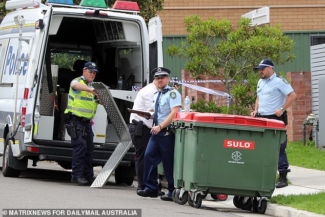 Police are seen outside a house in Sydney's southwest on Wednesday.