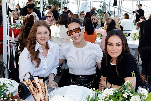 Kunis was sitting at a table with Enchanted actress Amy Adams and Wonder Woman star Gal Gadot.