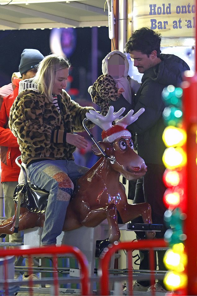 Jack and Roxy looked every inch the proud parents as they carried their daughter on a merry-go-round.