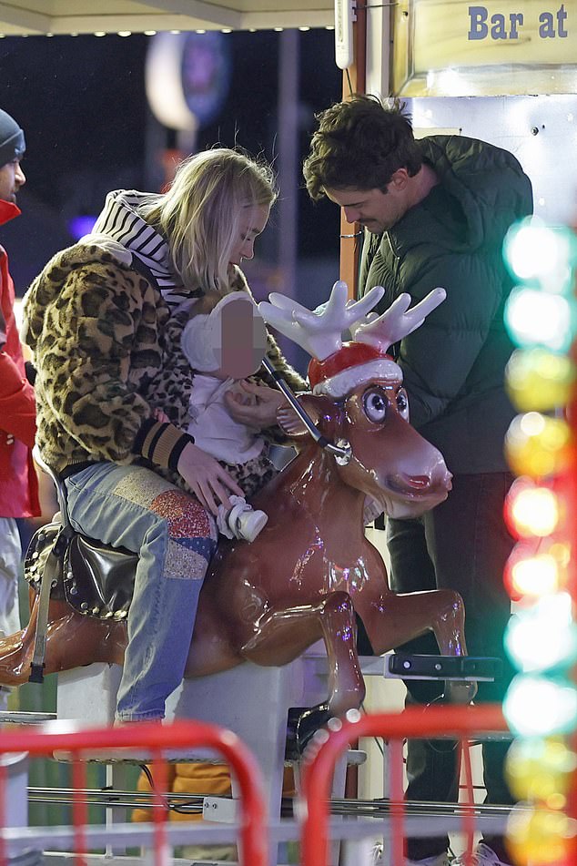 Jack helped Elsie ride a reindeer on a fairground ride.