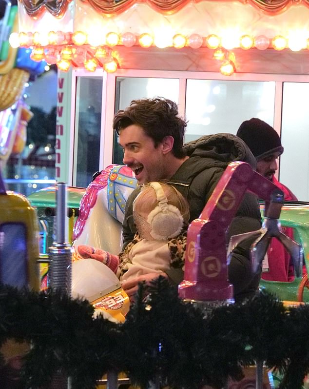 Jack seemed to be having fun as he sat in a pink excavator with Elsie on a carnival ride.