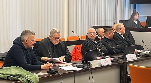 Markus Fritsche (left), Daniel Lins (fourth right in black turtleneck) and Yilmaz Tozturkan (behind) in court today