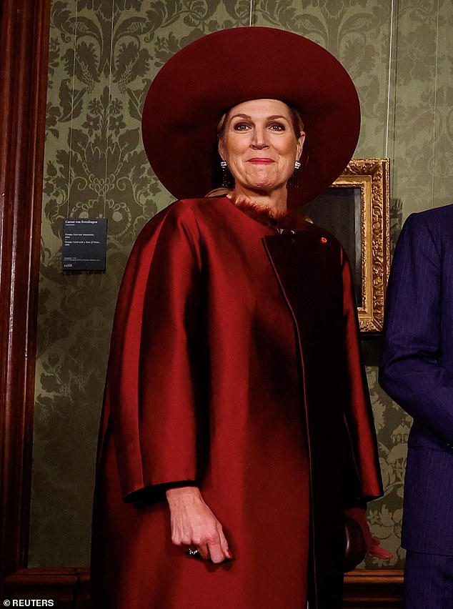 The royal mother of three had her nails done in a striking red and accessorized with garnet and diamond tassel earrings.