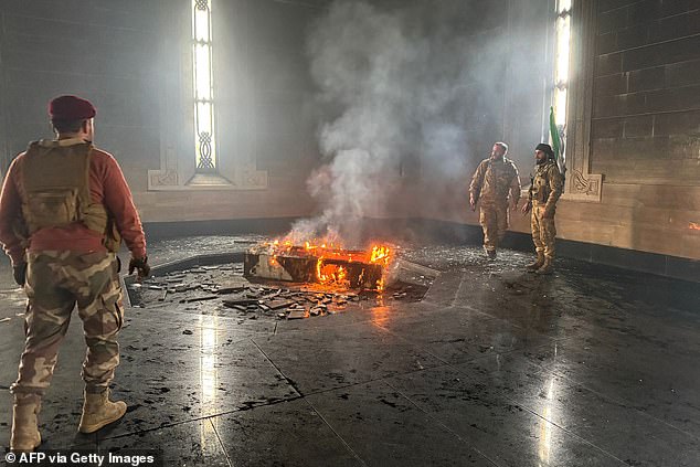 Rebel fighters set fire to Hafez al-Assad's grave. Syrians for the first time in six decades look to a future without the Assad family