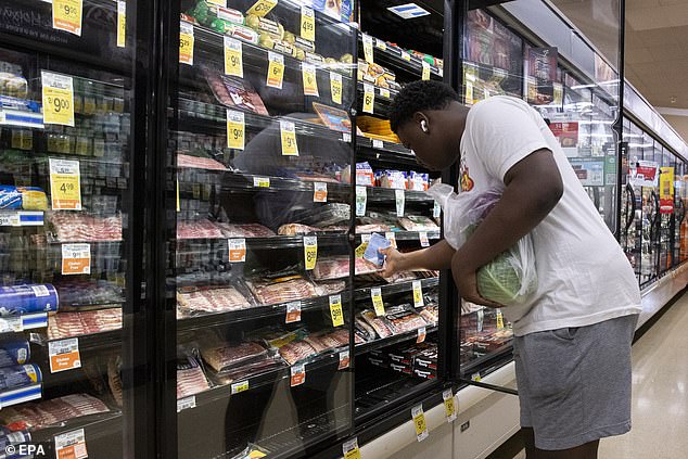 A customer picks up bacon at a Safeway supermarket, a subsidiary of Albertsons, in Washington, D.C., in October 2022