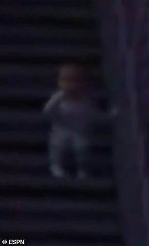 The baby is seen on the stairs