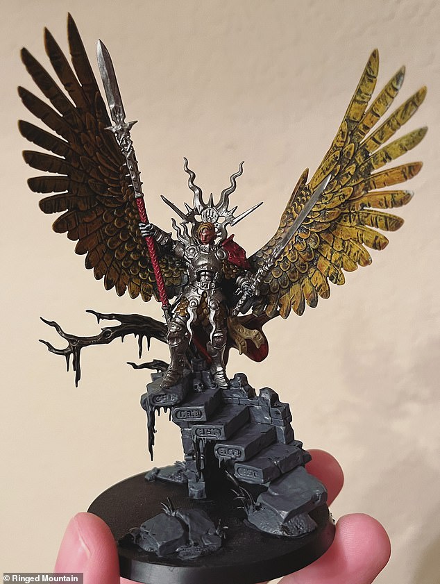 Fantasy: Warhammer fan 'Ringed Mountain' holds one of his models, a Stormcast Eternal